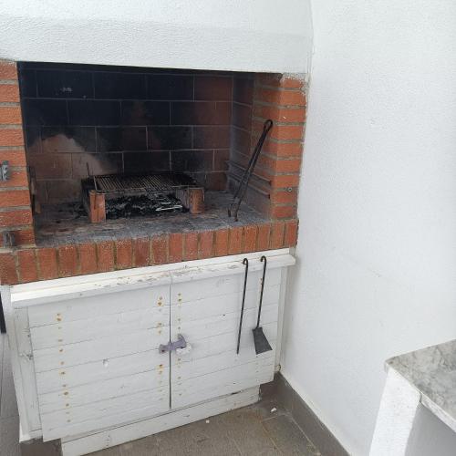 a brick fireplace sitting on top of a white cabinet at B&B Antico Porto Tarquinia in Tarquinia