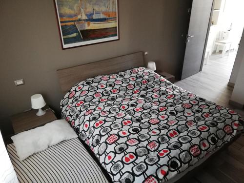 a bedroom with a bed with a comforter on it at B&B Antico Porto Tarquinia in Tarquinia
