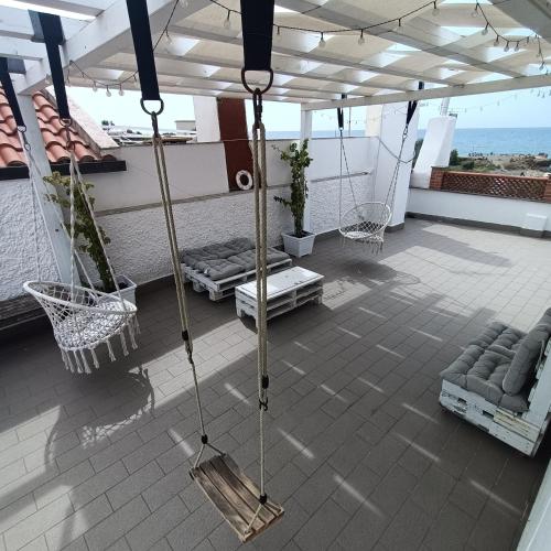 a balcony with swings and furniture on a ship at B&B Antico Porto Tarquinia in Tarquinia