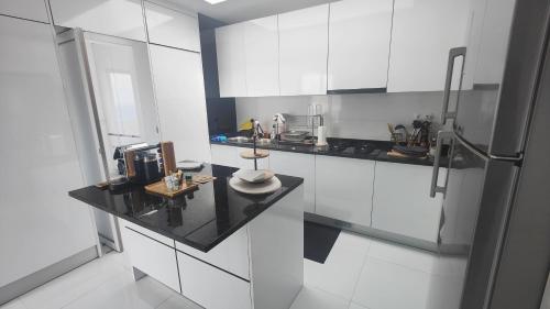 a kitchen with white cabinets and a black counter top at Luxury Penthouse with Private Pool, Ocean, City & Mountain view 6 Pers 2 BR in Lazareto