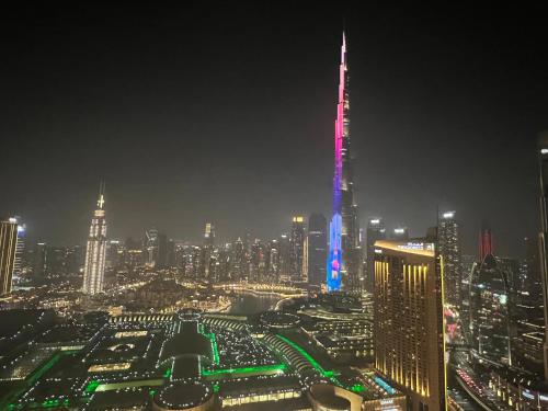 a night view of a city with a lit up skyline at 3+1 BR, Burj Khalif, Dubai Mall in Dubai