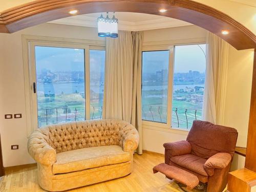 a living room with a couch and a chair at Luxury Villa By The Nile in Cairo