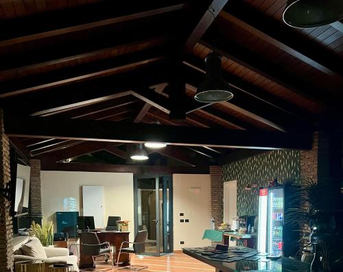 a living room with wooden ceilings and wooden beams at Virdamuri - Etna Country Resort in Giarre
