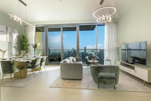 a living room with a table and chairs and a large window at 3+1 BR, Burj Khalif, Dubai Mall in Dubai