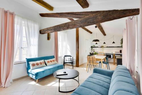 a living room with a blue couch and a table at Appartements hyper-centre de Marseille in Marseille