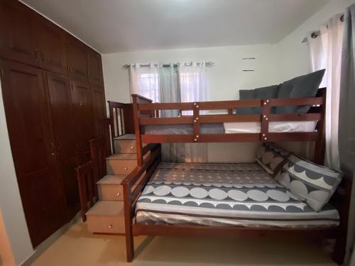 a bedroom with two bunk beds and a staircase at Santo Domingo Paradise V - #211 in La Estrella