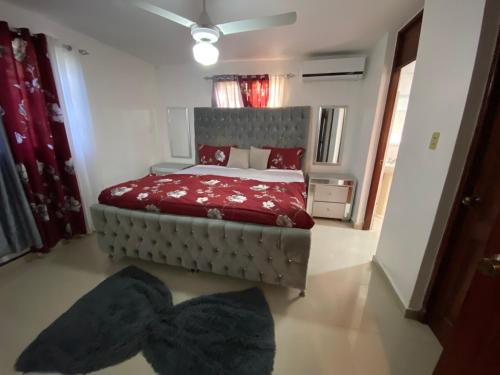 a bedroom with a bed with a red comforter at Santo Domingo Paradise V - #211 in La Estrella