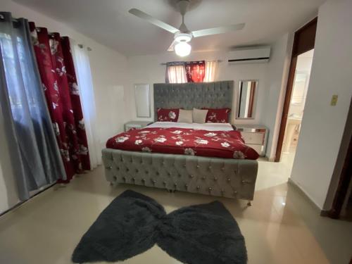 a bedroom with a bed with a bow tie on the floor at Santo Domingo Paradise V - #211 in La Estrella