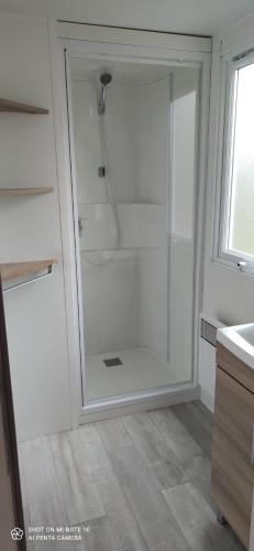 a shower with a glass door in a bathroom at Domaine de karlann 4Etoiles Mobil-home in Pont-Aven