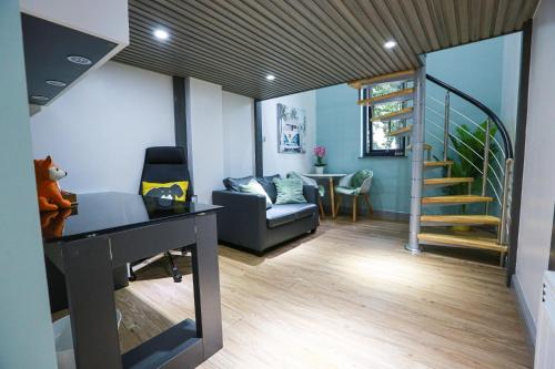 a living room with a staircase and a couch at B101 Boutique City Loft in Coventry