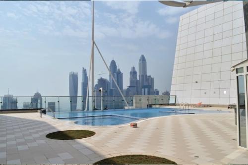 a swimming pool on top of a building with a city skyline at Breathtaking Skyscrapers View in Dubai
