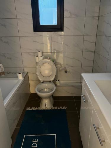 a bathroom with a toilet and a tub and a sink at New apt Stunning view steps from hospital! in Ramat Gan