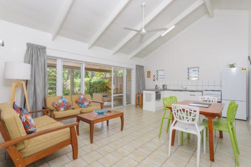 a kitchen and living room with a table and chairs at Rarotonga Daydreamer Escape in Rarotonga