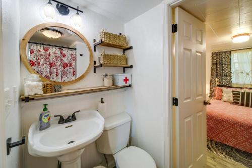 a bathroom with a sink and a mirror and a bed at Newport Cabin on Diamond Lake with Private Boat Dock in Newport