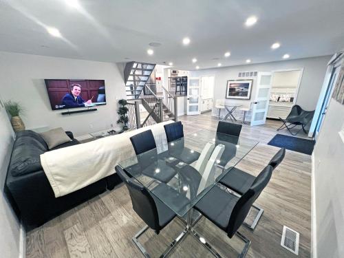 a living room with a couch and a glass table at Luxe Home Near Limeridge - Sleeps 11 - Pool in Hamilton