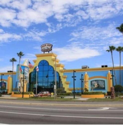 a yellow building with a sign on top of it at Summer Rayne in Cocoa Beach