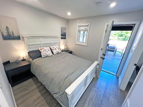 a bedroom with a bed and a door to a balcony at Limeridge Mall - Open Concept in Hamilton