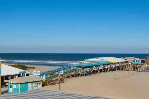 a train station on a beach next to the ocean at Summer Rayne in Cocoa Beach