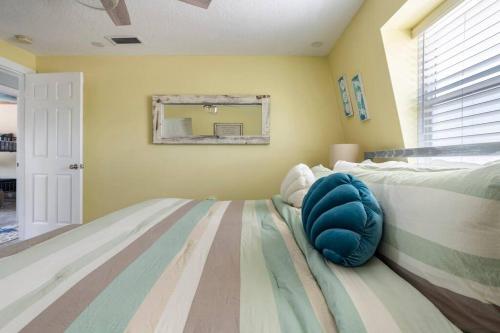 a bedroom with a bed with a pillow on it at Summer Rayne in Cocoa Beach