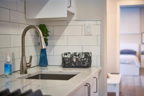 a kitchen with a sink and a counter top at Hamilton Mountain Plaza - King Bed - Main Floor in Hamilton