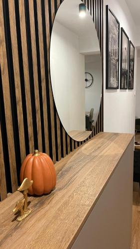 a pumpkin sitting on a counter in front of a mirror at Rezidencia pod Zámkom Bojnice Apartmán Luna in Bojnice