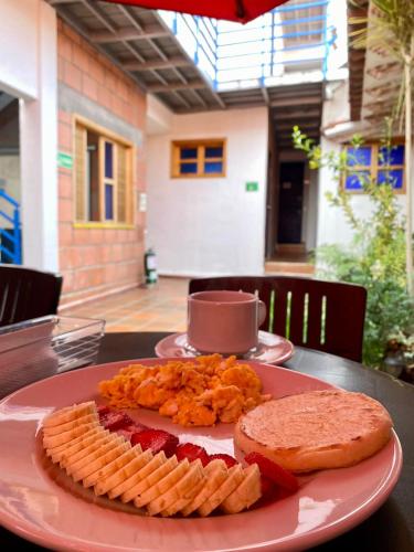 a plate of food with bread and crackers on a table at Zana Hotel Boutique in Bogotá