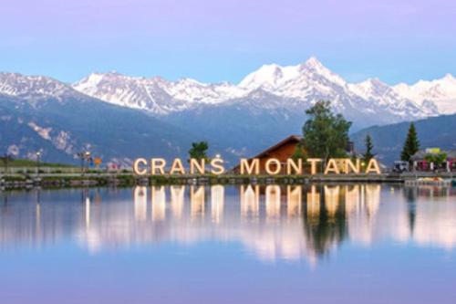 a sign that says grains montana with mountains in the background at Charmant logement vue dégagée Jeanne d'Arc in Crans-Montana