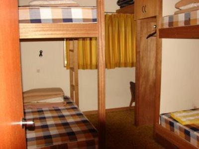 mały pokój z 2 łóżkami piętrowymi i drzwiami w obiekcie STI SKI LODGE w mieście Seki