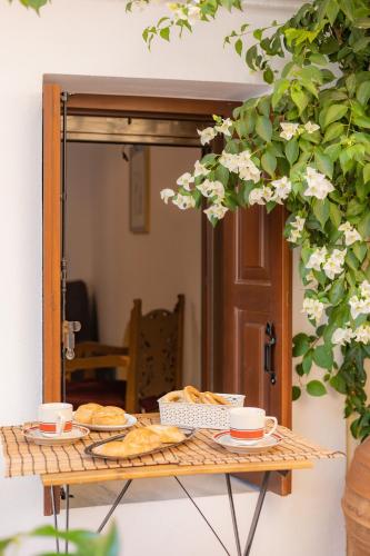 a table with bread and cups and a mirror at Kantirimi House - A1 in Symi
