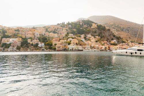 a large body of water with two boats in it at Kantirimi House - A1 in Symi