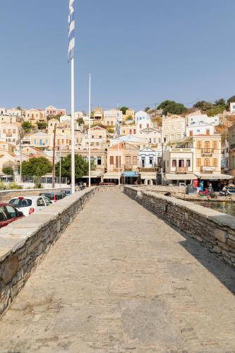 a long pier with a city in the background at Kantirimi House - A1 in Symi