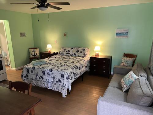 a bedroom with a bed and a couch at Boat House Studio - Water Front Pets WiFi Smart TV apts in Norfolk