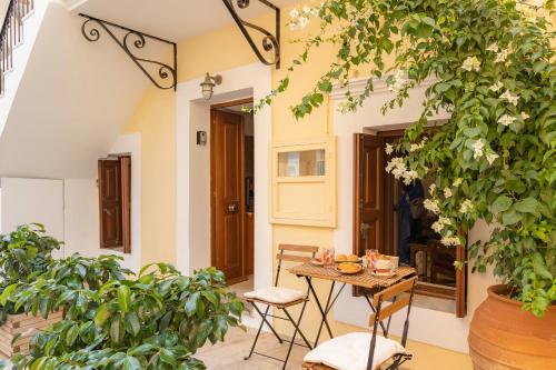 a patio with a table and some plants at Kantirimi House - A1 in Symi