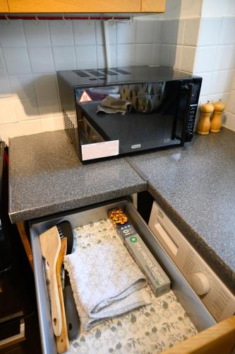 a drawer in a kitchen counter withtools in it at Charming 2-bedroom House near Bourton Park in Buckingham in Buckingham