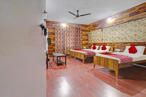 two beds in a room with wooden walls at Hotel Ab-i-Hayat in Srinagar