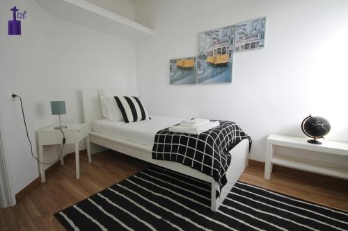 Katil atau katil-katil dalam bilik di Lisbon South Apartment