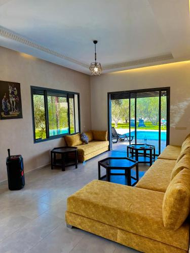 a large living room with two couches and tables at Villa White dreams in Marrakesh