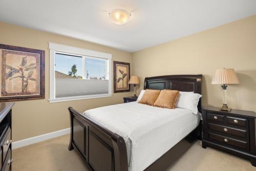 a bedroom with a large bed and a window at Private House Rental! Classic, Elegant, Comforting in Sidney