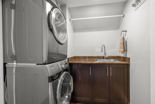 a kitchen with a washing machine and a sink at Private House Rental! Classic, Elegant, Comforting in Sidney