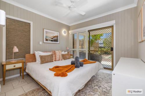 a bedroom with a large bed and a window at Kingscliff Ocean Vista in Kingscliff