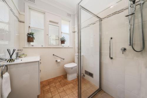 a bathroom with a shower and a toilet and a sink at Pine Lodge in Blackheath