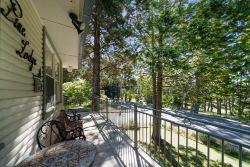 a balcony with two benches and a fence at Pine Lodge in Blackheath