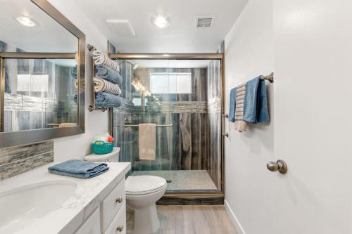 a bathroom with a shower and a toilet and a sink at Luxurious fairway condo resort country club in Palm Desert