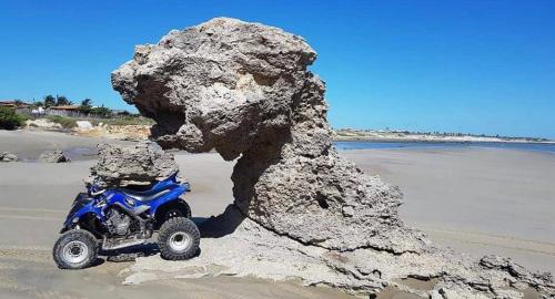 a toy atv parked next to a rock on the beach at Flatsuico in Fortim