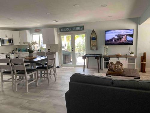 a living room with a couch and a table and a kitchen at key Deer Retreat/direct gulf access/hot tub in Big Pine Key