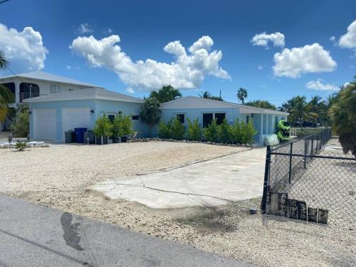 a house with a fence in front of it at key Deer Retreat/direct gulf access/hot tub in Big Pine Key
