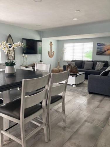 a living room with a table and chairs and a couch at key Deer Retreat/direct gulf access/hot tub in Big Pine Key