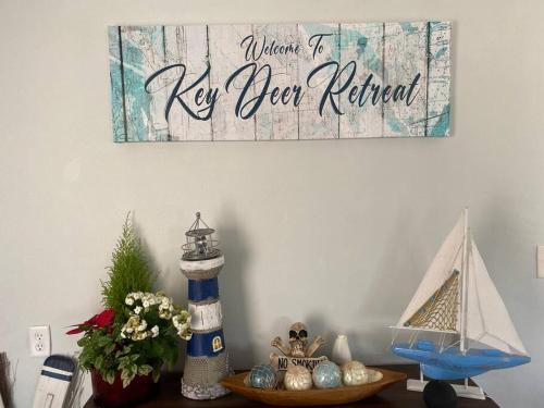 a table with a sign that reads when it ne open refined at key Deer Retreat/direct gulf access/hot tub in Big Pine Key