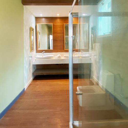 a bathroom with a shower and a sink and a mirror at Rio Holiday Boutique Hotel in Niterói