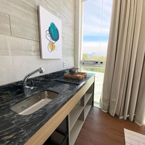 a kitchen with a sink and a window at Rio Holiday Boutique Hotel in Niterói